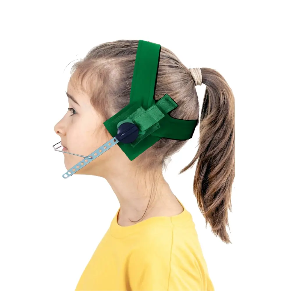 Profile view of a child wearing a green headset with a microphone attached to the side is used for speaking or listening devices